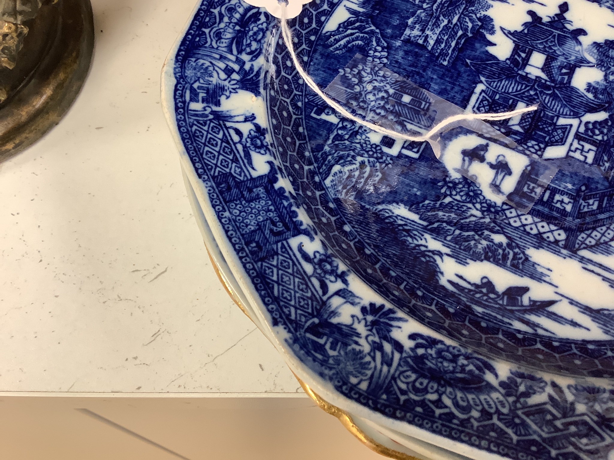 A Chinese export armorial soup plate, a large 18th century Chinese export porcelain footed punch bowl on stand, A Chinese blue and white plates and a pearlware plate